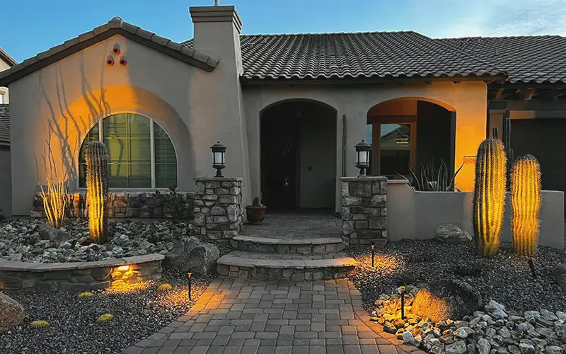 Designed front entry with paver walkway and landscape lighting