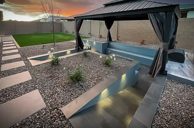 Custom-designed backyard with gazebo, sunken fire feature and turf