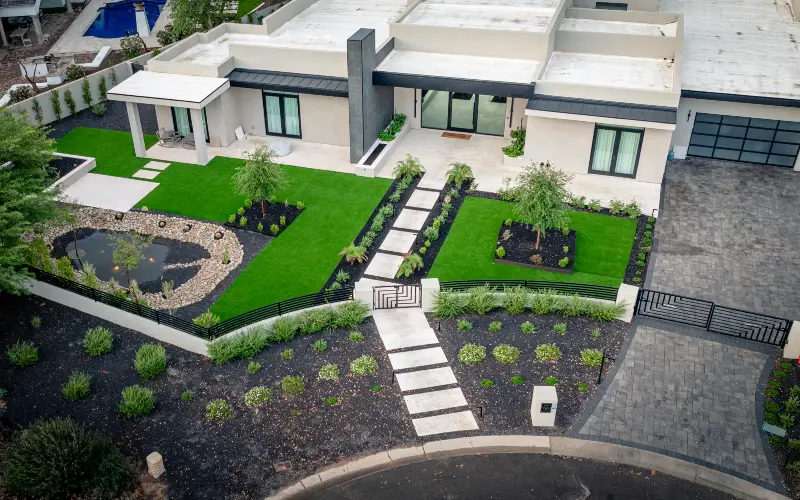 Custom backyard transformation with pool, turf and travertine patio