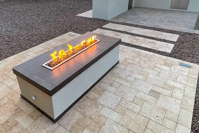 Custom fire pit table on a paver patio