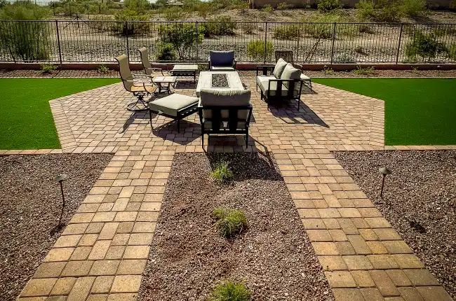 Custom paver patio installation with desert backdrop