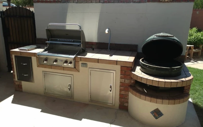 Outdoor kitchen with built-in grill and ceramic smoker