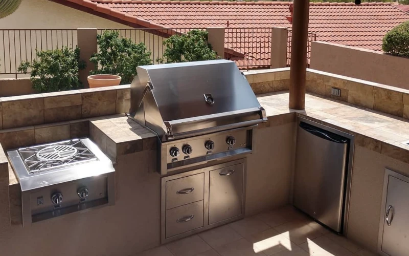 Elevated outdoor kitchen with built-in grill and side burner