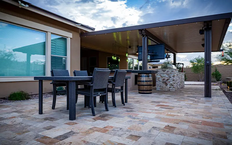 Covered patio with dining and lounge seating and stone bar