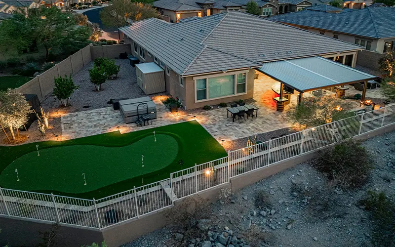 Finished backyard with putting green and covered patio built from a dirt yard