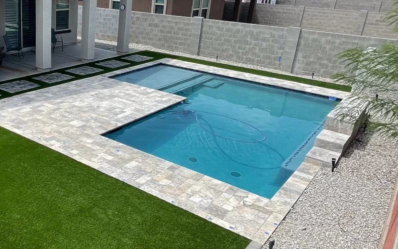 In-ground pool with raised paver deck