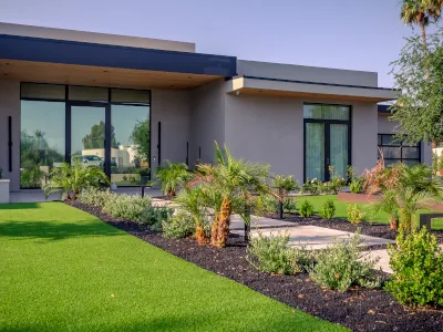 Front entry artificial turf installation with desert landscaping